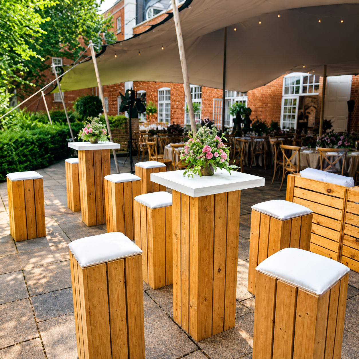 Rustic wooden poseur tables with stools at an outdoor corporate networking event by Carby & Co Event Production